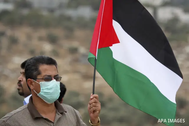 Palestinian and foreign activists take part in a protest against Israel's separation barrier in the West Bank village of Bilin near Ramallah on September 17, 2010. Photo by Eyad Jadallah