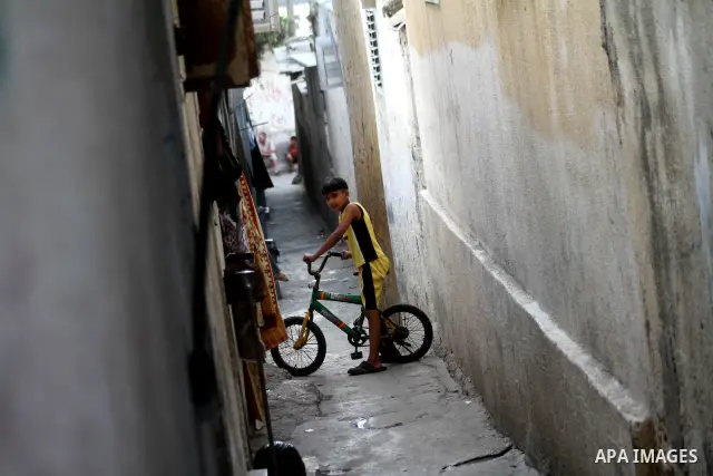 Palestinian children play in an alley of al-Shatea refugee in Gaza city on Sept.18,2010. The director of UNRWA operations, 'John Ging' assured,at a press conference, that UNRWA would not allow the exposure of the Palesti...