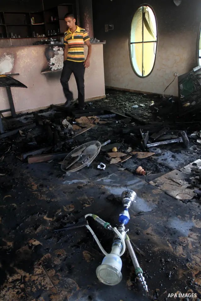 A Palestinian man inspects the damage at Crazy Water Park in Gaza City on Sept. 19, 2010 . Masked gunman torched the three-month-old entertainment park in the Hamas-run Gaza Strip on Sunday after neutralizing guards, own...