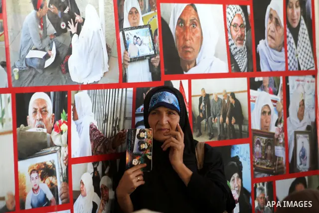 Palestinian women hold pictures of jailed relatives during a protest calling for the release of Palestinian prisoners from Israeli jails at the Red Cross office in Gaza City on Sept 20,2010 . Photo by Ashraf Amra