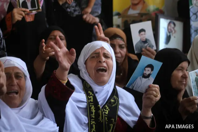 Palestinian women hold pictures of jailed relatives during a protest calling for the release of Palestinian prisoners from Israeli jails at the Red Cross office in Gaza City on Sept 20,2010 . Photo by Ashraf Amra
