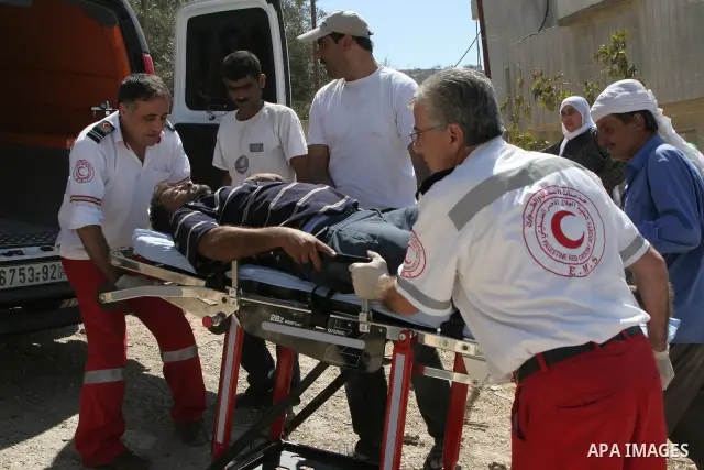 Palestinian medical workers carrying a Palestinian farmer who was wounded after scuffles with Israeli settlers , in the village of Burin, near Nablus in the West Bank , Monday, Sept. 20,2010 . Palestinian farmers said th...