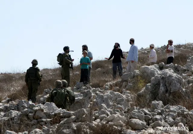 Jewish settlers argue with an Israeli soldiers during clashes between residents of the Israeli Bracha settlement and Palestinian farmers from the West Bank Burin village on September 21, 2010. The fight broke when settle...