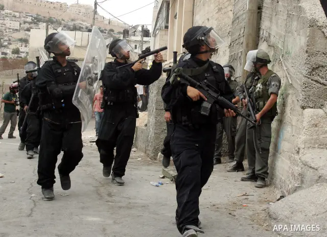 Israeli policemen take position during the clashes in the east Jerusalem neighborhood of Silwan, Wednesday, Sept. 22, 2010. Violence erupted after a 32-year-old Palestinian laborer was killed by a private security guard...