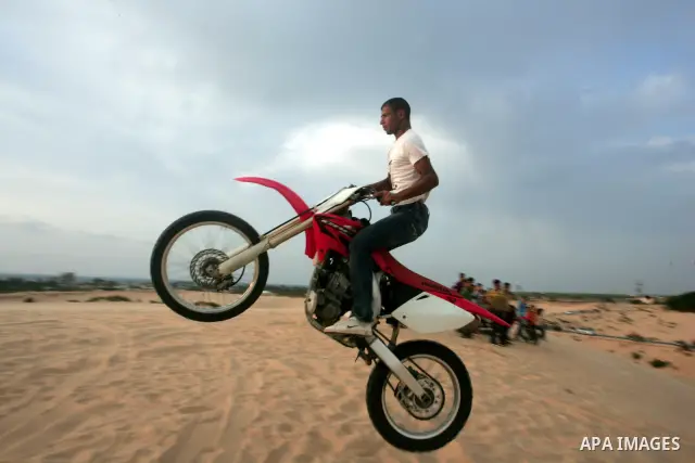Palestinians ride their motorcycles as part of their weekend activities in the southern Gaza Strip city of Rafah on September 24, 2010. Hundreds of Palestinians spend their free time in the southern part of Gaza Strip ri...