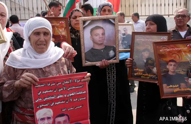 Palestinian women hold pictures of relatives held in an Israeli jail during a protest calling for the release of prisoners, in the West Bank city of Nablus, Saturday Sept. 25, 2010. Photo by Wagdi Eshtayah