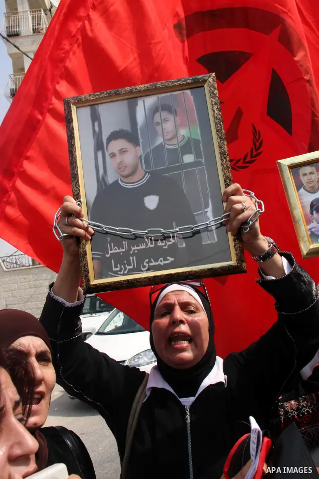 Palestinian women hold pictures of relatives held in an Israeli jail during a protest calling for the release of prisoners, in the West Bank city of Nablus, Saturday Sept. 25, 2010. Photo by Wagdi Eshtayah