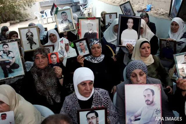 Palestinians protest outside the International Red Cross offices in east Jerusalem on September 25, 2010, calling on Israel to release their imprisoned relatives. More than 7,000 Palestinians, including 270 under the age...