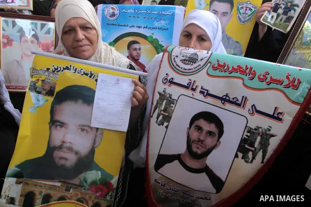 Palestinian women hold pictures of jailed relatives during a protest calling for the release of Palestinian prisoners from Israeli jails at the Red Cross office in Gaza City on Sept 27,2010 . Photo by Mohammed Asad