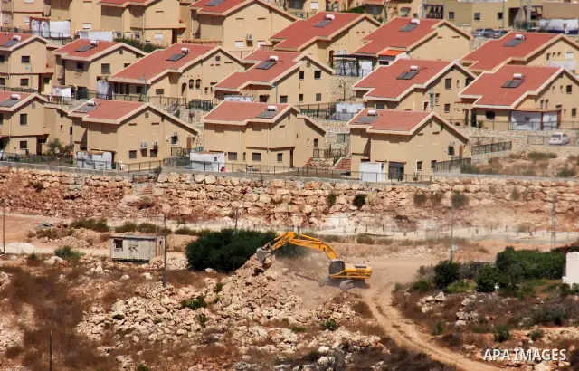 Israeli earth-moving equipment works in the Jewish settlement of Kiryat Netafim, near the West Bank village of Salfit, Monday on Sept. 27, 2010. Senior Palestinian official Yasser Abed Rabbo said Monday that President Ma...