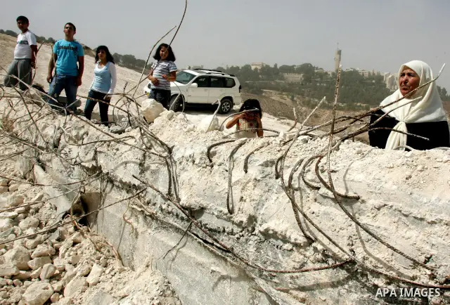 A Palestinian family reacts near their home after it was demolished by Israeli police in Jerusalem's Palestinian Atur village, on September 27, 2010. Photo by Mahfouz Abu Turk