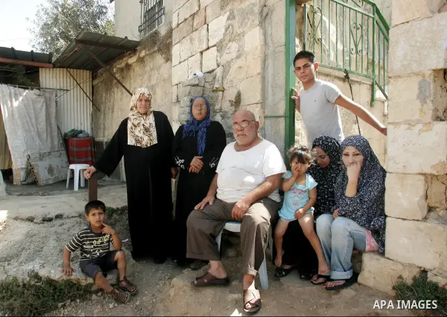 Palestinian family stand in front of their house in Shiekh Jarrah, the East Jerusalem neighborhood, on Sept 28, 2010, Israeli settlers threatened the family to take over Palestinian house in the neighborhood. Photo by Ma...