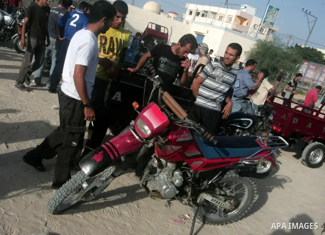 Palestinians men within the motorcycle market in Khan Younis, southern Gaza Strip on Sept. 29,2010 . In this market, vendors display their motorcycle's to sell them for the buyers , as hundreds of Palestinians spend thei...