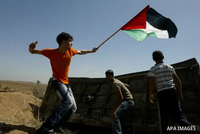 Palestinians hurl stones at Israeli troops (not pictured) during a demonstration to mark the 10th anniversary of the Al-Aqsa Intifada , in the east of Al Shejaeya area in the east of Gaza City, in Gaza Strip on Sept. 29,...