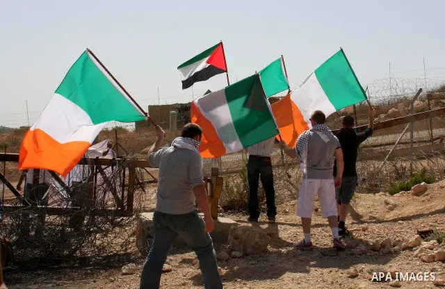 Palestinians and foreign activists take part in a protest against Israel's separation barrier in the West Bank village of Bilin near Ramallah, Friday, Oct. 1, 2010. U.S. Middle East envoy George Mitchell was shuttling be...