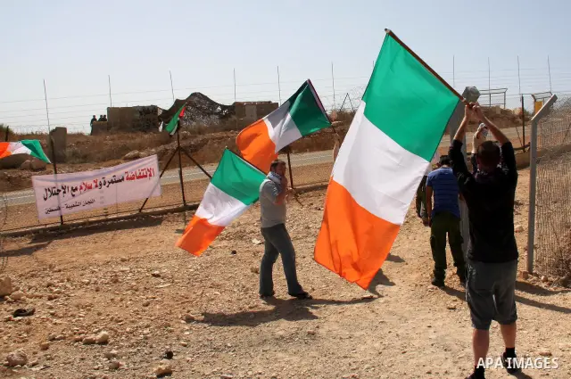Palestinians and foreign activists take part in a protest against Israel's separation barrier in the West Bank village of Bilin near Ramallah, Friday, Oct. 1, 2010. U.S. Middle East envoy George Mitchell was shuttling be...