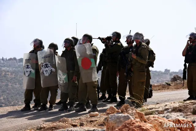Israeli soldiers stand guards during a protest against Israel's separation barrier in the West Bank village of Bilin near Ramallah, Friday, Oct. 1, 2010. U.S. Middle East envoy George Mitchell was shuttling between Israe...