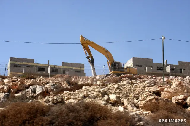 Israeli bulldozers work on the site of a new housing project as Jewish settlement in the West Bank of Ramallah, Friday, Oct. 1, 2010 . Photo by Wagdi Eshtayah . Photo by Wagdi Eshtayah