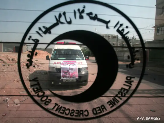 Palestinian members of the Red Crescent distribute leaflets to people in the remote places in the southern Gaza Strip city of Rafah on Oct. 3,2010 to mark the International Day for the ambulance and emergency.. Photo by...