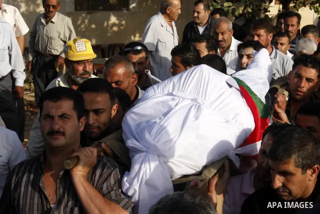 Palestinian mourners carry the body of Palestinian Shehda Karaja, 55, during his funeral near the Israeli occupied West Bank city of Hebron on October 4,2010. Karaja was died after a heart attack after being fear and inh...