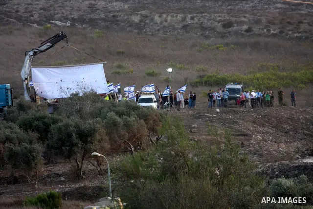 Jewish settlers from the Israeli settlement of Yitzhar demonstrate near the Palestinian village of Burin in the Israeli occupied West Bank, several kilometers from the northern city of Nablus on October 4, 2010, which th...