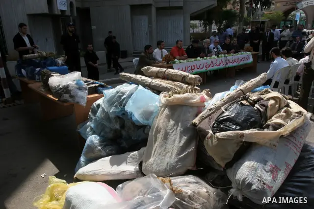 Palestinian Hamas police officers display large quantities of the seized drugs during a press conference , and they will burn this amount of drugs , in Gaza City on Oct 5,2010 . Photo by Mohammed Asad