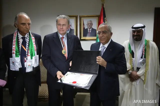 Palestinian Prime Minister Salam Fayyad during his meeting with the Chief of the International Olympic Committee, Jack Rouge in the West Bank city of Ramallah on Oct. 5,2010. Photo by Mustafa Abu Dayeh / Pool