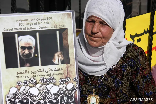Palestinians hold pictures of the Secretary-General of the PFLP, Ahmad Saadat during a protest calling for the release of Palestinian prisoners from Israeli jails in the West Bank city of Nablus, Tuesday, Oct. 5, 2010. P...