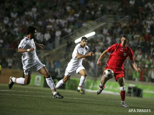 Players of Palestine and Jordan are seen during a friendly match attened by the President of the International Olympic Committee (IOC) Jacques Rogge, Palestinian prime minister Salam Fayyad and Palestinian Olympic Commit...