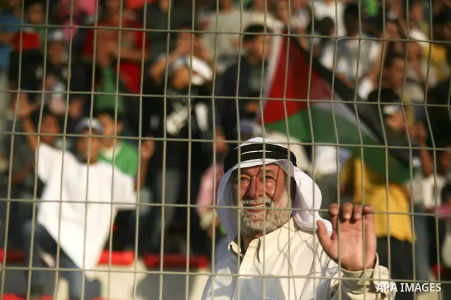 Fans gather during a friendly match between Palestine and Jordan attened by the President of the International Olympic Committee (IOC) Jacques Rogge, Palestinian prime minister Salam Fayyad and Palestinian Olympic Commit...