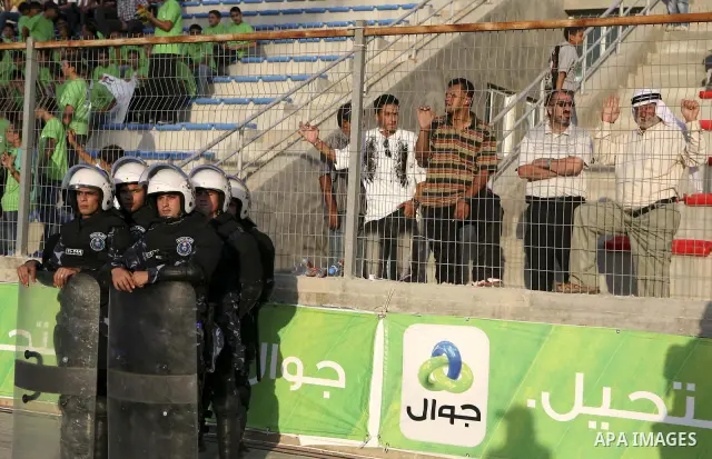 Fans gather during a friendly match between Palestine and Jordan attened by the President of the International Olympic Committee (IOC) Jacques Rogge, Palestinian prime minister Salam Fayyad and Palestinian Olympic Commit...