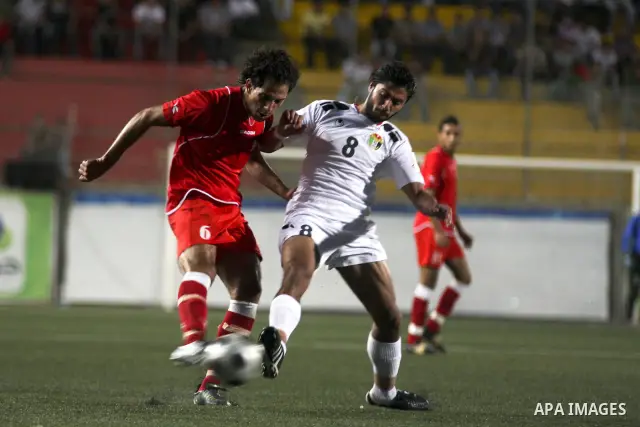 Players of Palestine and Jordan are seen during a friendly match attened by the President of the International Olympic Committee (IOC) Jacques Rogge, Palestinian prime minister Salam Fayyad and Palestinian Olympic Commit...