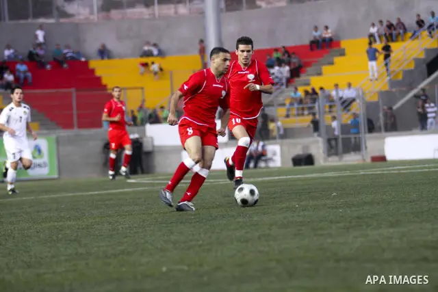 Players of Palestine and Jordan are seen during a friendly match attened by the President of the International Olympic Committee (IOC) Jacques Rogge, Palestinian prime minister Salam Fayyad and Palestinian Olympic Commit...