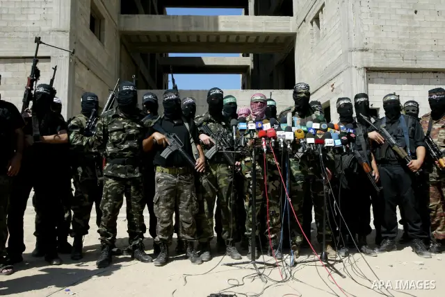 Masked Palestinian militants, some from Hamas, hold a press conference in Gaza City on October 6, 2010. About two dozen gunmen from various groups accused Palestinian President Mahmoud Abbas' security forces of arresting...
