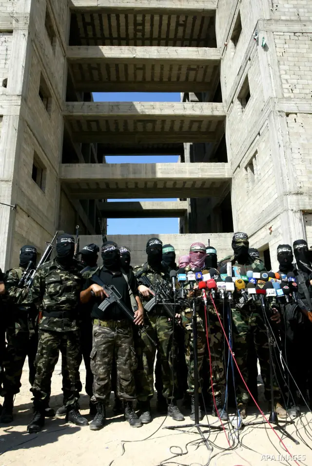 Masked Palestinian militants, some from Hamas, hold a press conference in Gaza City on October 6, 2010. About two dozen gunmen from various groups accused Palestinian President Mahmoud Abbas' security forces of arresting...