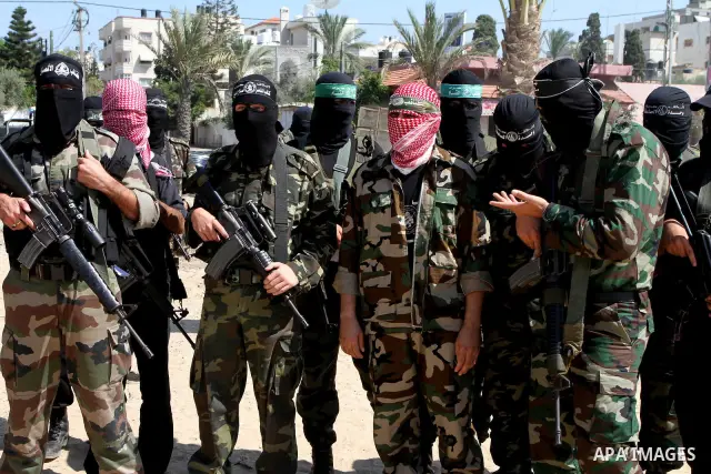Masked Palestinian militants, some from Hamas, arrive to a press conference in Gaza City on October 6, 2010. About two dozen gunmen from various groups accused Palestinian President Mahmoud Abbas' security forces of arre...