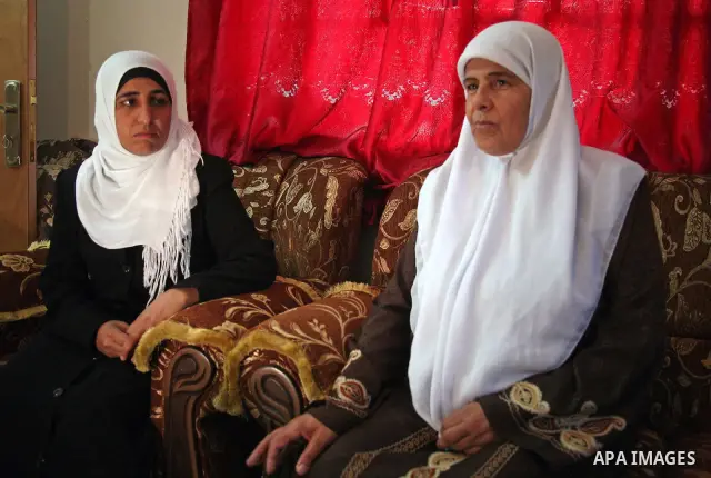 The Palestinian woman shows the Video where she appears blinded eyes and handcuffed while an Israeli soldier dances around her in the West Bank city of Bethlehem on October 6 2010, the Israeli army announced that invisti...