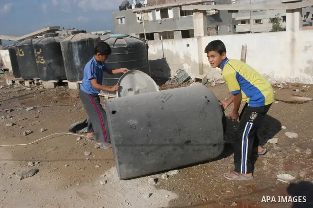 Palestinian boys inspect the damage of training base following an Israeli airstrike, in Gaza City, Thursday, Oct. 7, 2010. Palestinian official said that Israeli aircraft struck Hamas training base for security forces of...