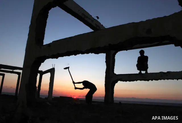 Palestinians work to re-manufacture cement from the remains of ruins of Palestinian buildings that were destroyed during the Israeli war against Hamas in the Gaza Strip, in the west of Beit Lahiya town in the northern Ga...