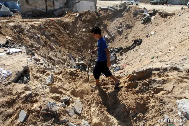 Palestinians boys inspect the damage of training base following an Israeli airstrike, in Gaza City, Thursday, Oct. 7, 2010. Palestinian official said that Israeli aircraft struck Hamas training base for security forces o...
