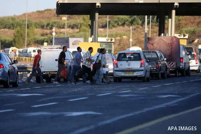 Palestinian workers walk to cross the Isreali controlled Modiin ( Bet seira ) checkpoint, between the West Bank and the Jewish settlement of Modiin Illit and all of Israeil , as they head to work in Israel and nearby set...