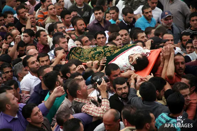 Palestinians carry the body of a Hamas militant Mamoun al-Natsha during his funeral in the West Bank city of Hebron, Friday, Oct. 8, 2010. Israeli troops killed two senior Hamas militants in an early-morning raid in the...