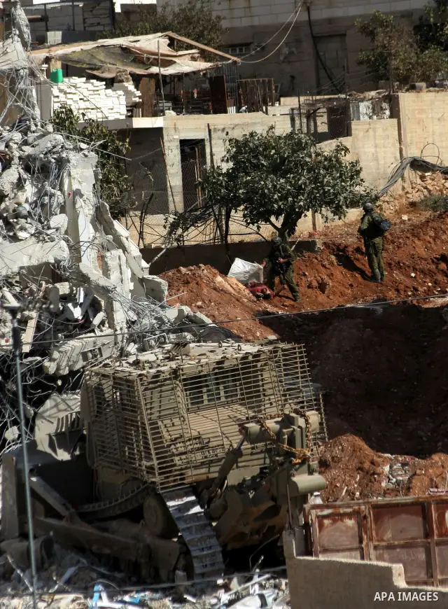 Israeli soldiers demolish a house after a raid at the West Bank city of Hebron, Friday, Oct. 8, 2010. Israeli troops killed two senior Hamas militants in an early-morning raid in the city on Friday, the Israeli military...