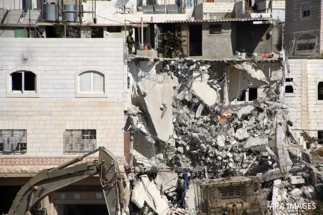 Israeli soldiers demolish a house after a raid at the West Bank city of Hebron, Friday, Oct. 8, 2010. Israeli troops killed two senior Hamas militants in an early-morning raid in the city on Friday, the Israeli military...