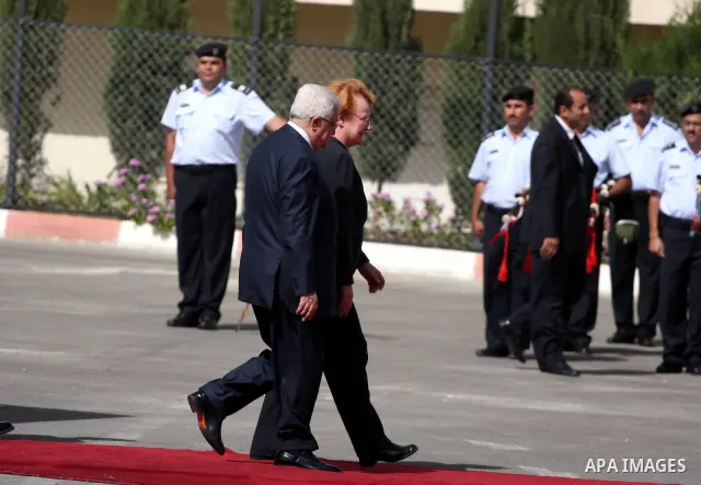 Palestinian President Mahmoud Abbas and Finland's President Tarja Halonen walk past an honour guard before their meeting in the West Bank city of Ramallah on October 14, 2010 . Photo by Issam Rimawi