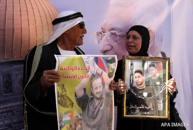 Palestinians hold pictures of relatives, held in Israeli jails, during a protest calling for their release in West Bank city of Nablus,Thursday, Oct 14, 2010 .Over 6,000 Palestinian prisoners currently held in Israeli pr...