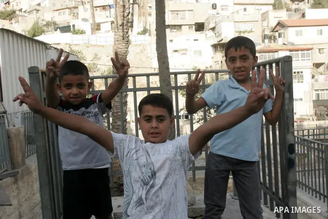 Palestinian children wave their hands with victory sign in the Arab east Jerusalem neighborhood of Silwan on Oct 14,2010. Palestinian children suffer from alot of attacks from Jewish settlers and Israeli soldiers as a Pa...