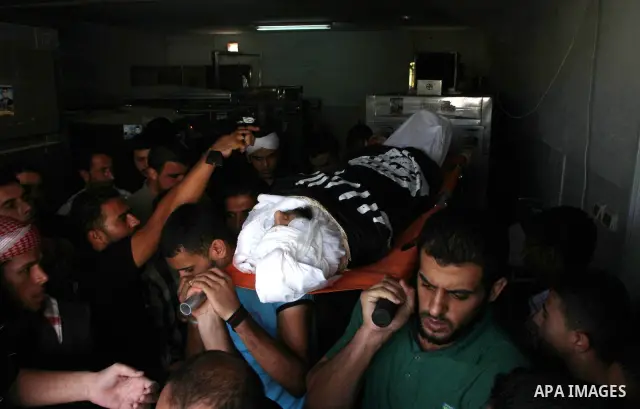 Palestinian mourners carry the body of militant Mahmud Washa during his funeral at the Shati refugee camp in Gaza City on October 17, 2010. Two Palestinians were killed and a third wounded in the pre-dawn Israeli air str...