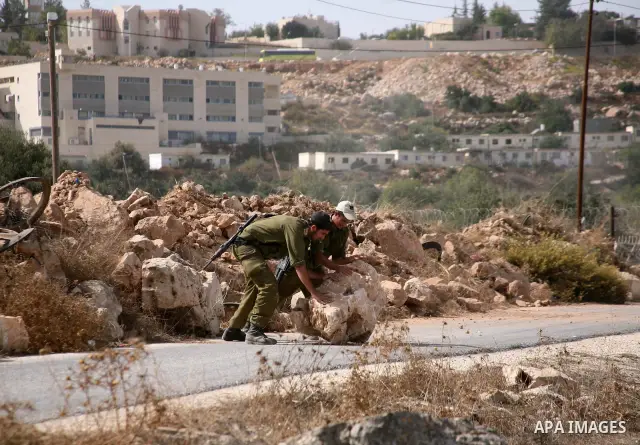 Israeli bulldozers work at the back side of the Israeli settlement of Kiryat Arba near Kharsina sattlemen outside the West Bank city of Hebron on October 17, 2010 . Photo by Najeh Hashlamoun