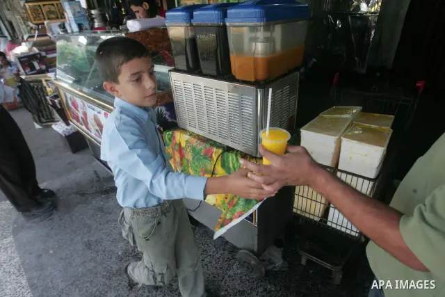 Palestinians are buying refreshments to cool themselves because of the high air temperatures, in the southern Gaza Strip town of Rafah, on October 18, 2010 . Photo By Khaled Khaled